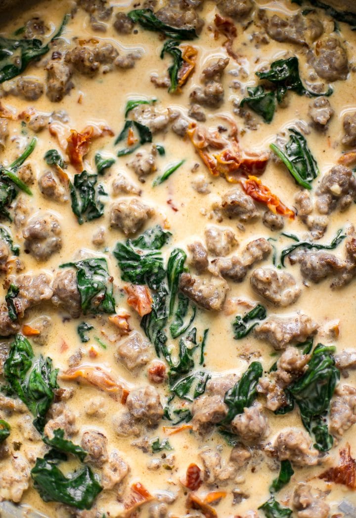 close- up of Italian sausage, spinach, sun-dried tomato cream sauce