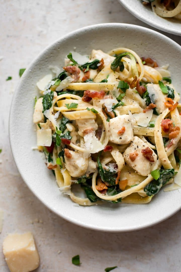 bowl of creamy chicken bacon spinach pasta with parmesan