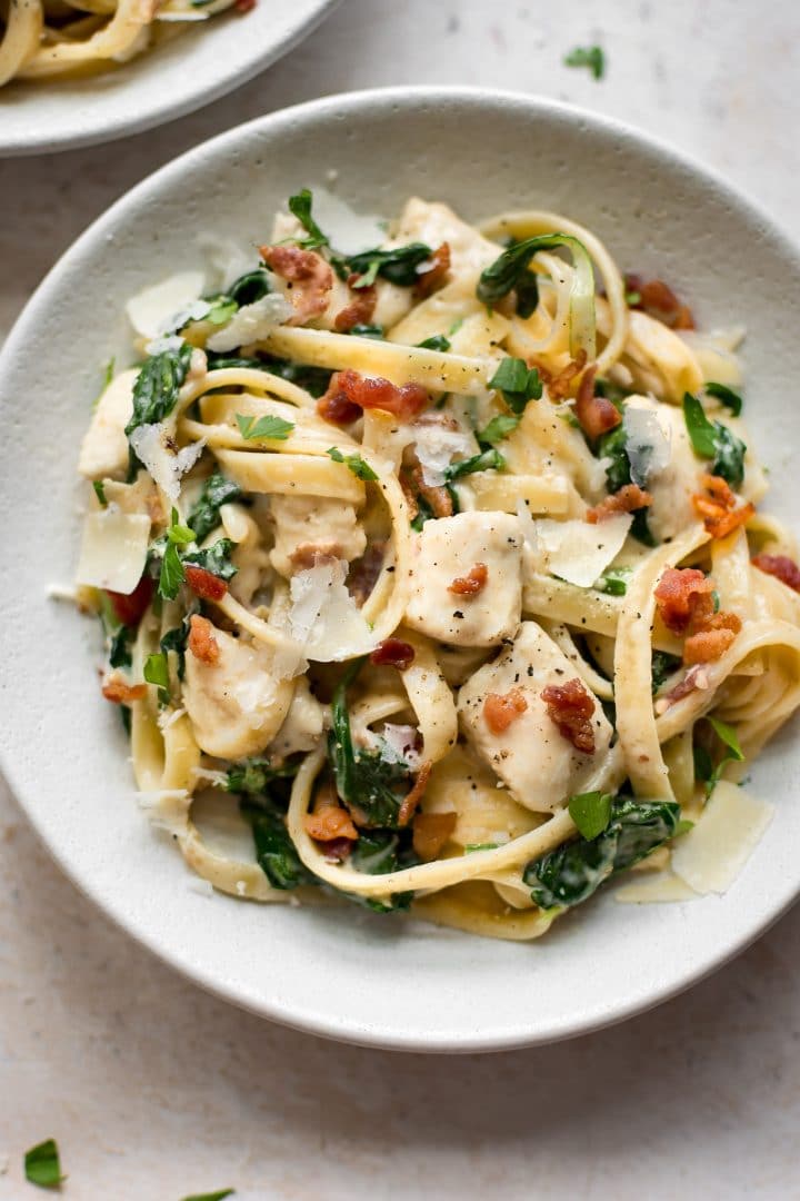 close-up of easy chicken bacon spinach pasta in a white bowl