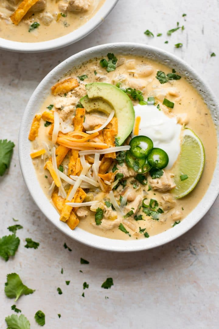 This white chicken chili recipe is crazye with cream cheese, so it's deliciously creamy and tangy. Tender chicken breast and yummy toppings make this the best chicken chili ever!