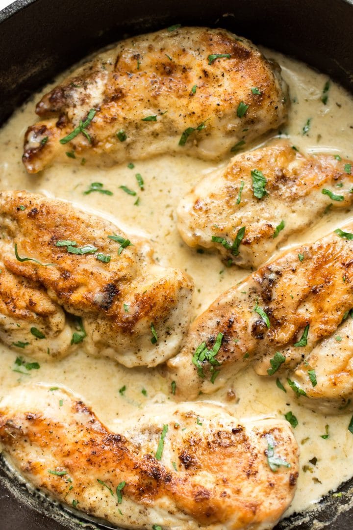 close-up of cast iron skillet with easy white wine chicken recipe with a cream sauce