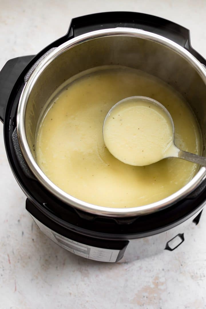 an Instant Pot electric pressure cooker with silky potato leek soup and a ladle