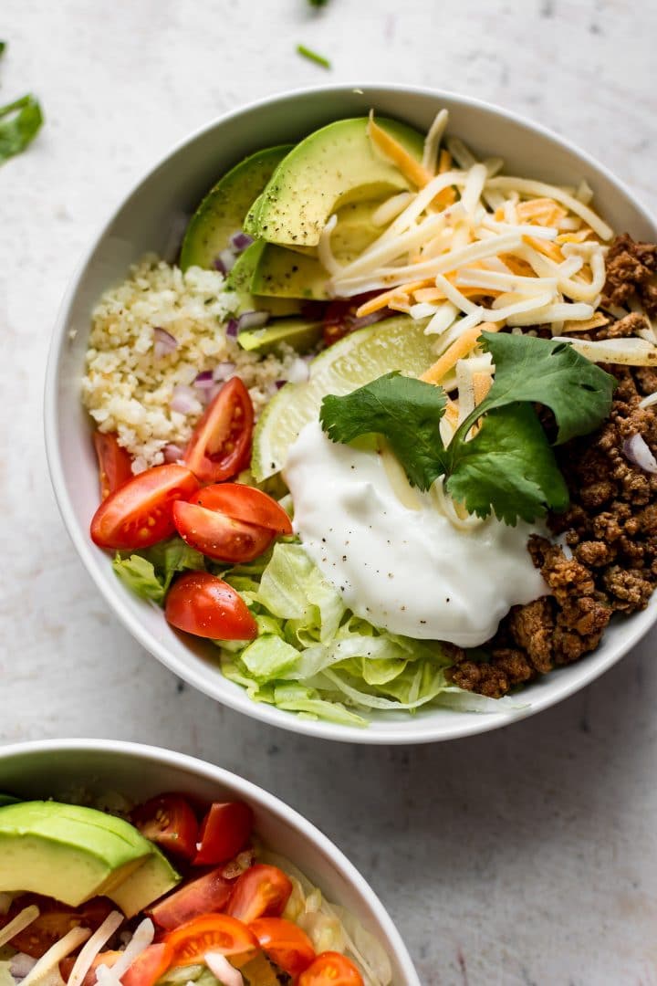 easy low-carb taco bowl with ground beef, cauliflower rice, and avocado