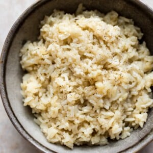 It's easy to make the most flavorful, tender, savory, and creamy (but no cream) rice in your Instant Pot! A quick and easy side dish the whole family will love.