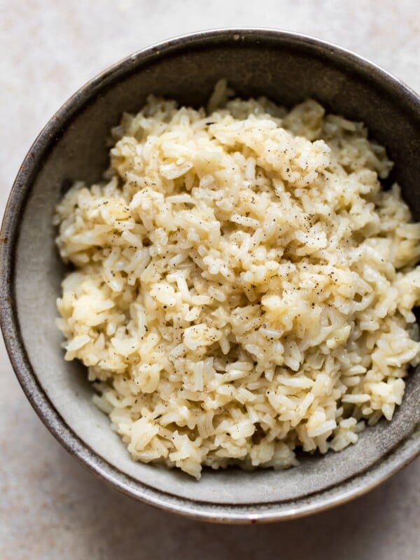It's easy to make the most flavorful, tender, savory, and creamy (but no cream) rice in your Instant Pot! A quick and easy side dish the whole family will love.