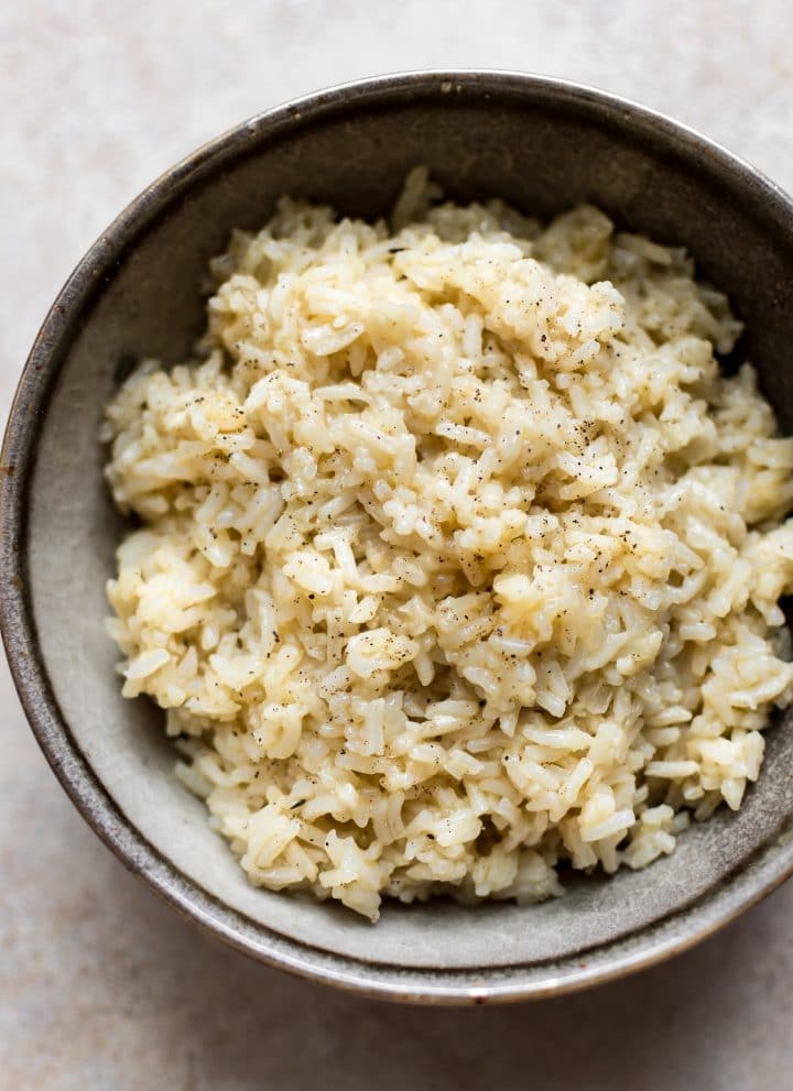 It's easy to make the most flavorful, tender, savory, and creamy (but no cream) rice in your Instant Pot! A quick and easy side dish the whole family will love.