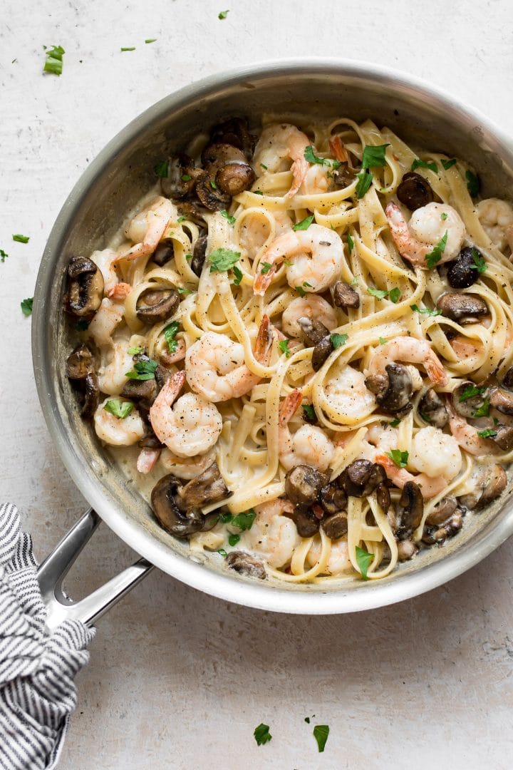 metal skillet with creamy shrimp and mushroom pasta