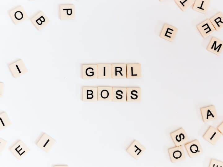 Scrabble letters spelling out "girl boss"