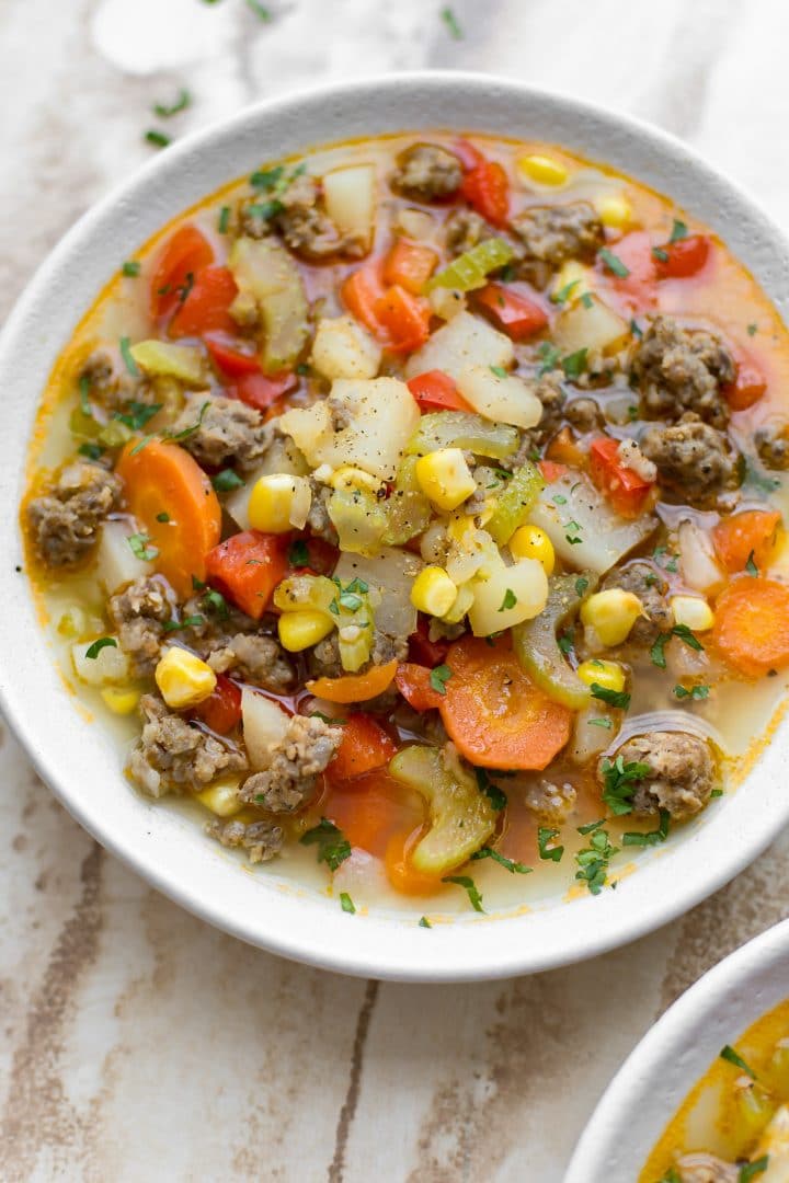 close-up of easy sausage and vegetable soup in a white bowl