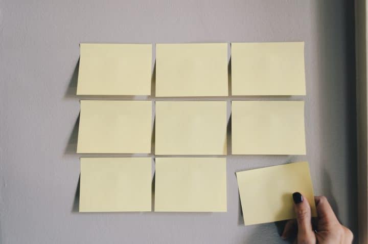 nine yellow post-it notes on a wall