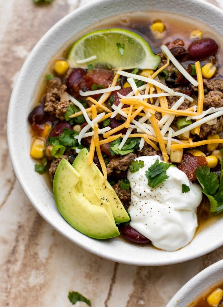 This slow cooker beef taco soup recipe is easy and delicious. Perfect for a family meal!