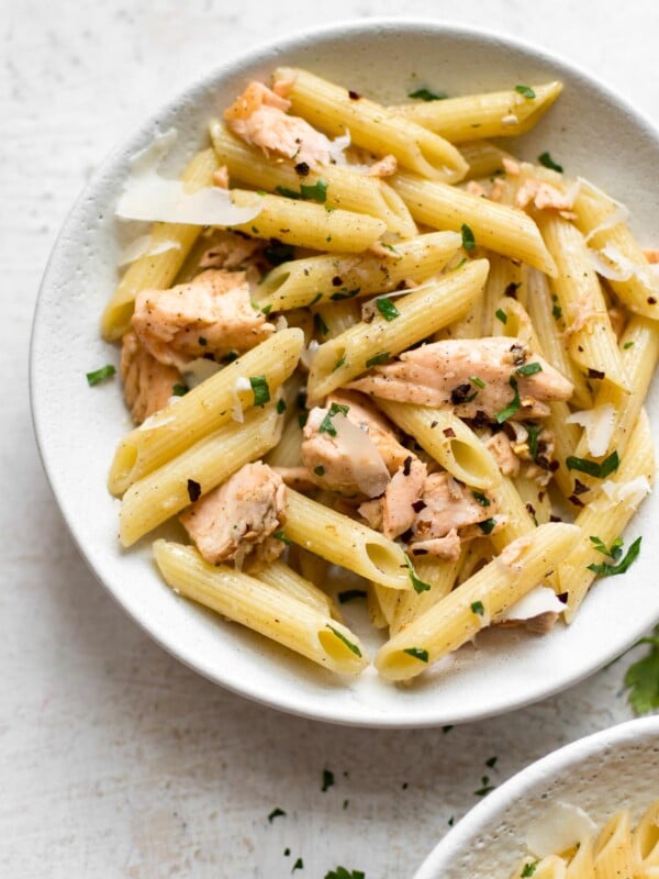 Garlic butter salmon pasta in a white bowl