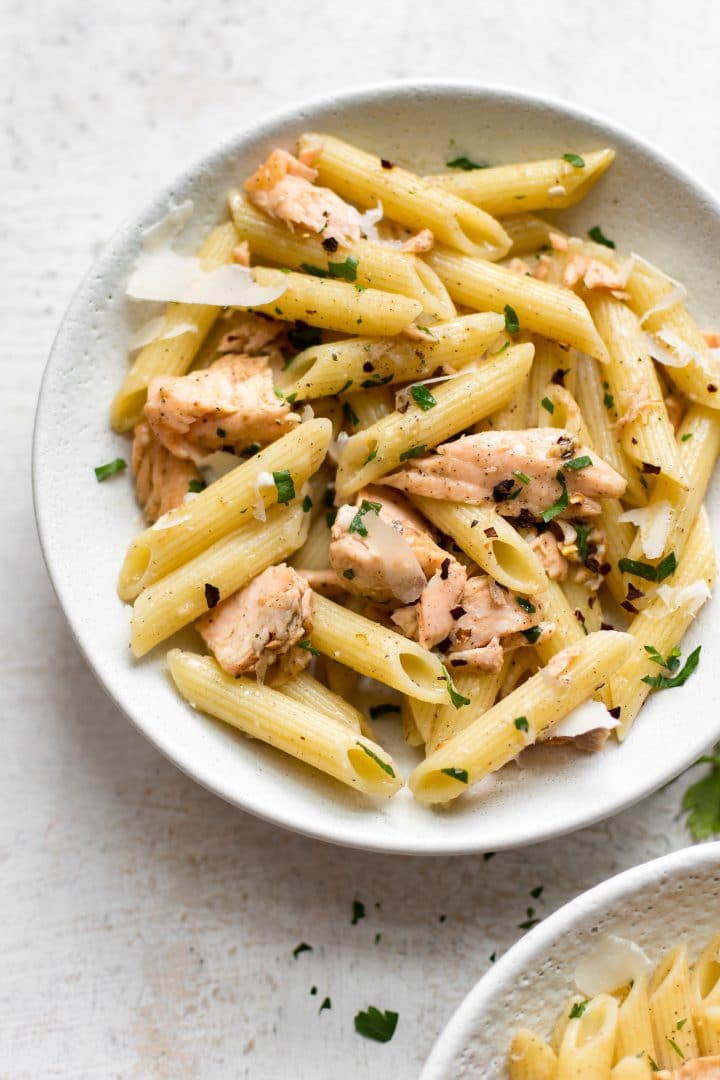 Garlic butter salmon pasta in a white bowl