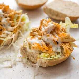 This Instant Pot buffalo chicken recipe is simple and crazy good. Your favorite hot wing flavor makes the best sandwiches. Perfect with ranch or blue cheese dressing!