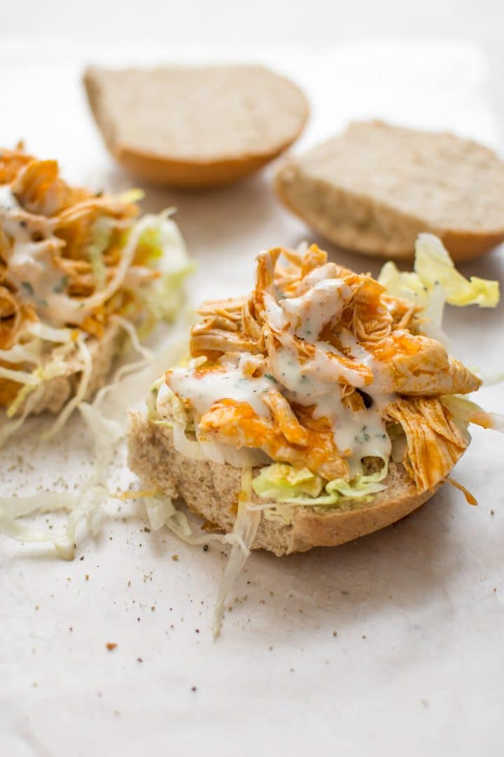 two sliders with instant pot buffalo chicken, lettuce, and ranch dressing