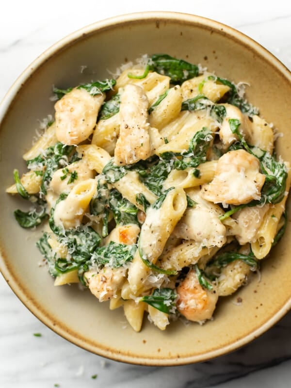 a bowl of creamy chicken spinach pasta