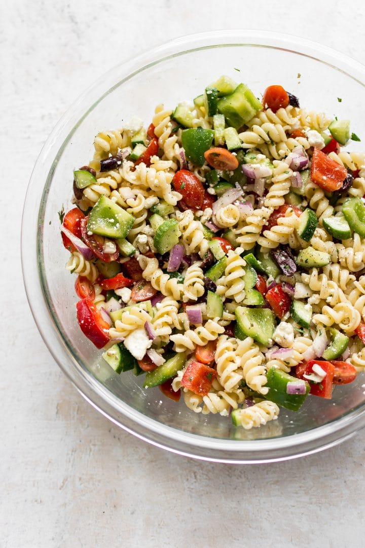 Glass prep bowl with cold Greek pasta salad