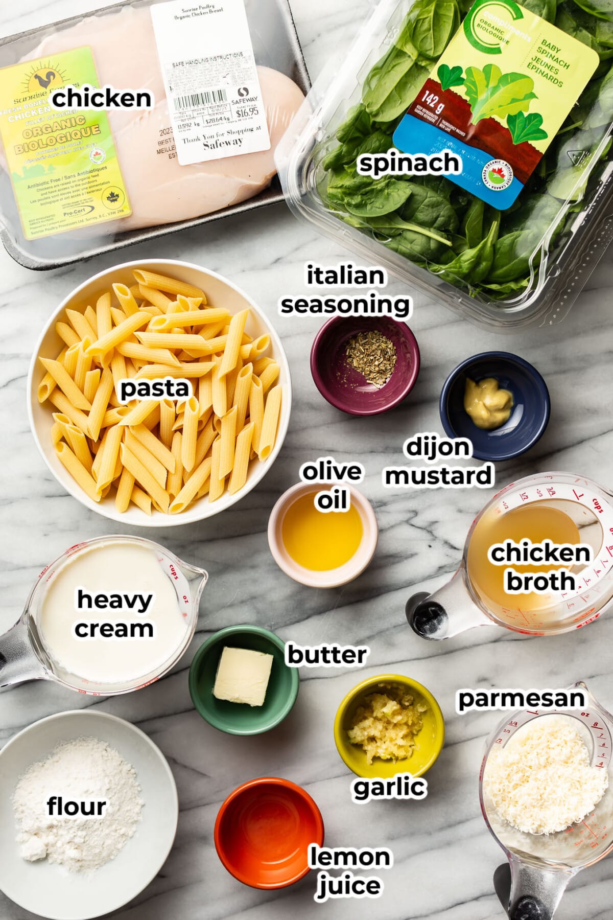 ingredients for creamy chicken spinach pasta in prep bowls