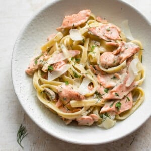 lemon dill salmon over fettuccine in a bowl