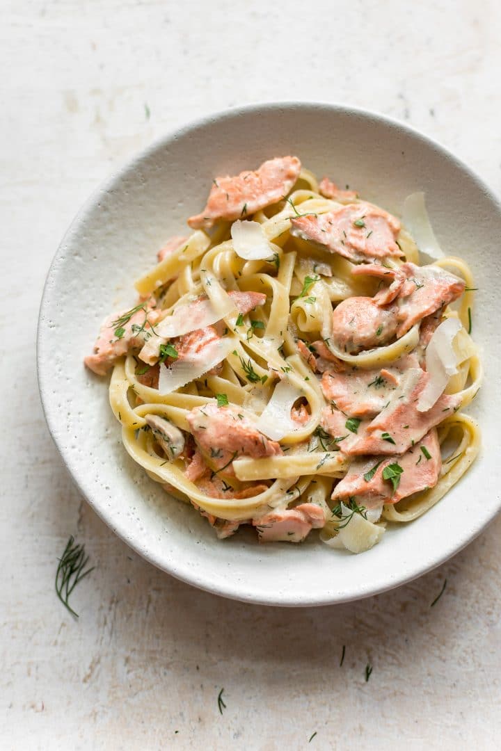 lemon dill salmon over fettuccine in a bowl