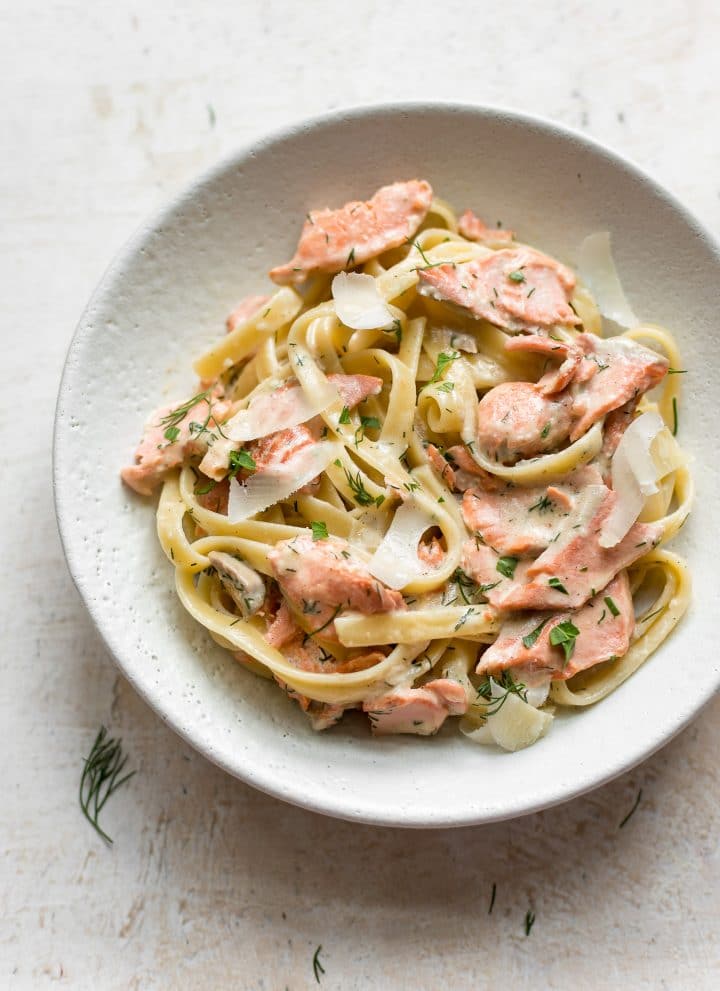 lemon dill salmon over fettuccine in a bowl