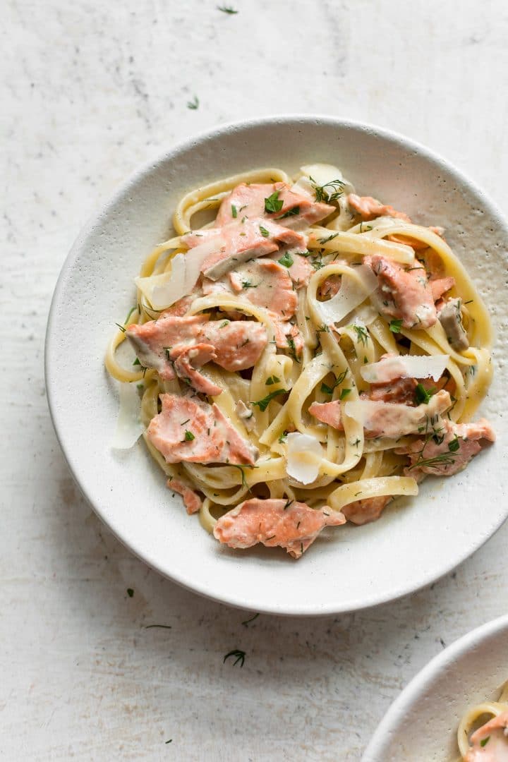Salmon with creamy lemon dill sauce and pasta in a bowl