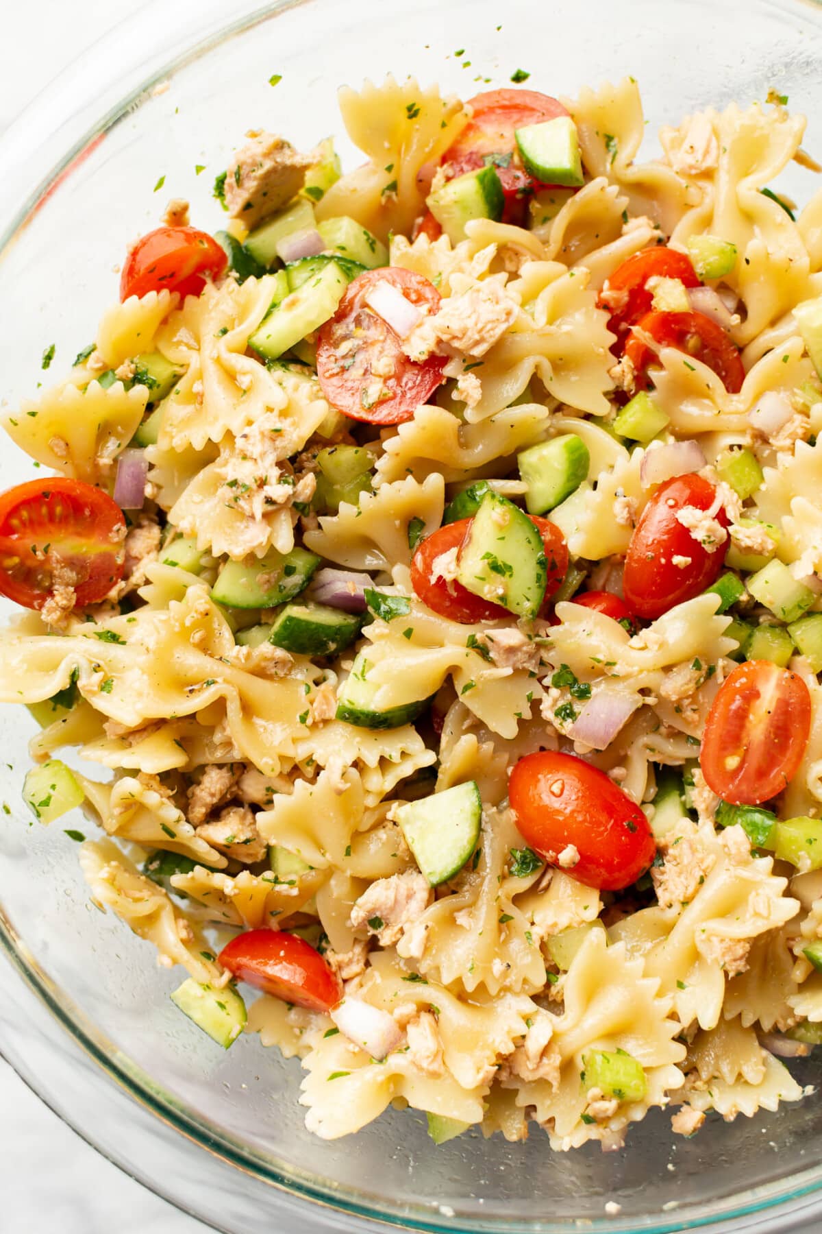 a glass prep bowl with tuna pasta salad