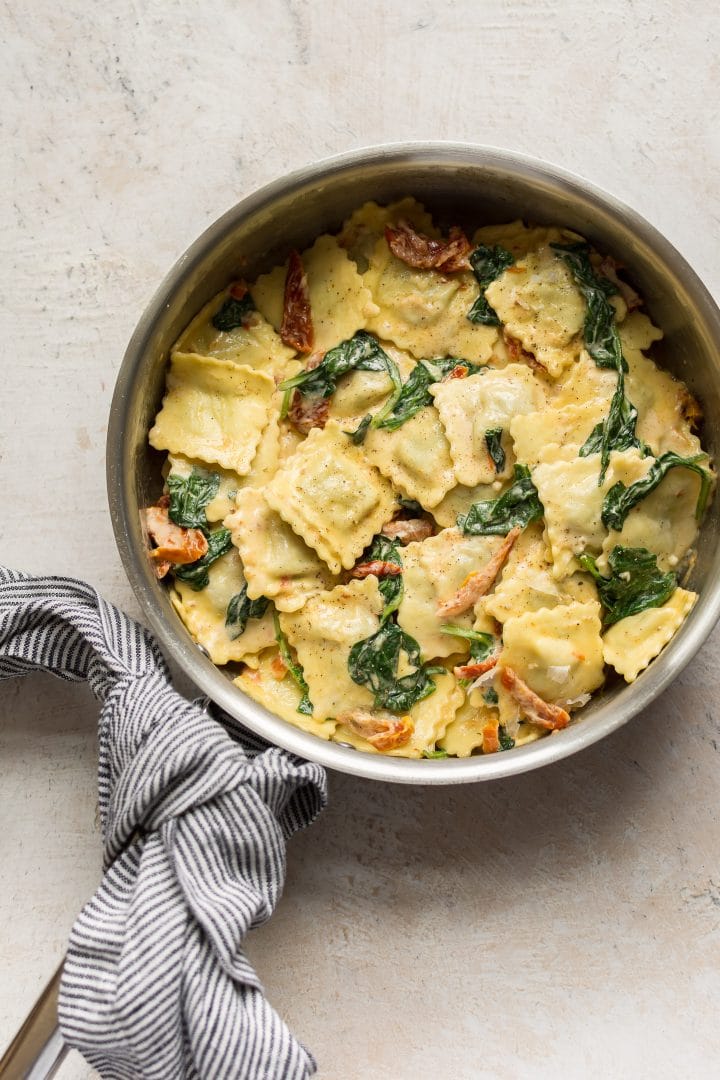 creamy tuscan ravioli in a skillet