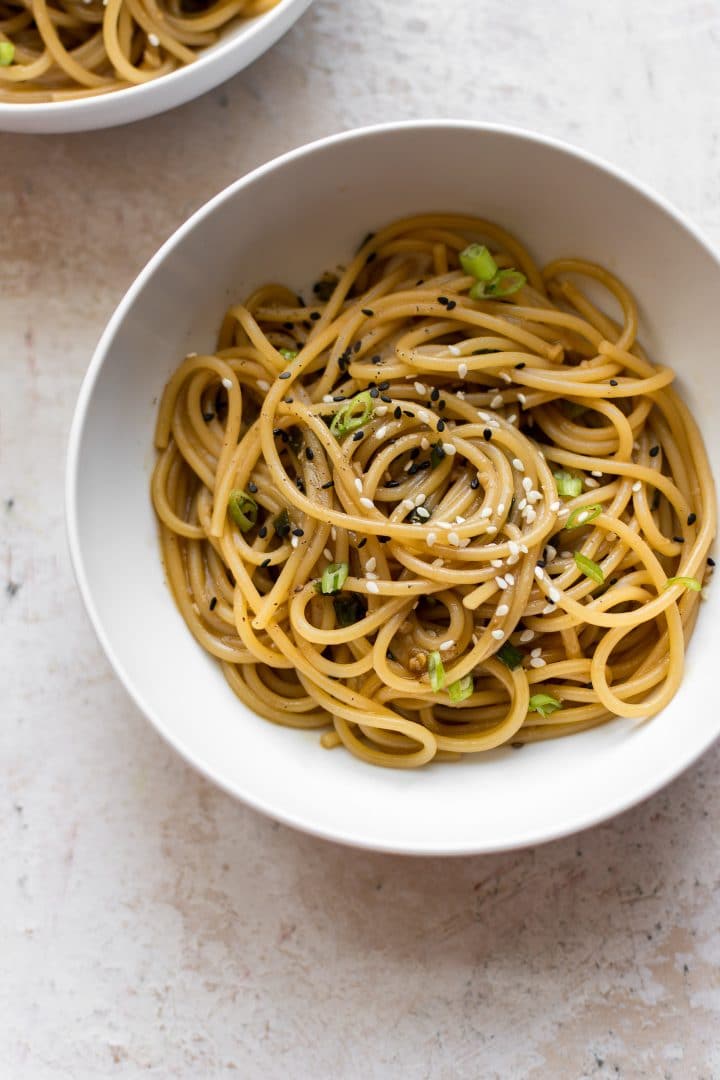 buttery garlic ginger noodles in a white bowl