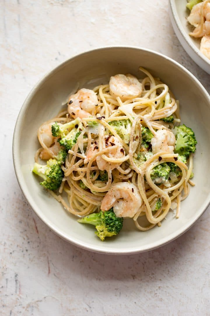 two bowls of shrimp and broccoli pasta
