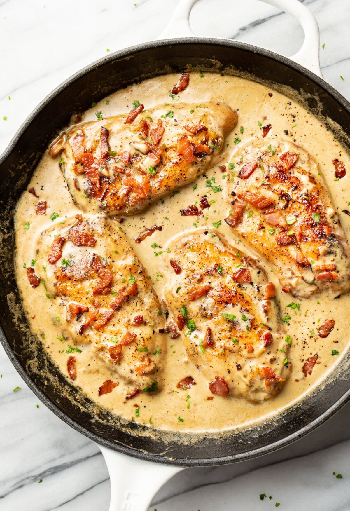 a cast iron skillet with creamy bacon chicken