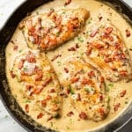 a cast iron skillet with creamy bacon chicken