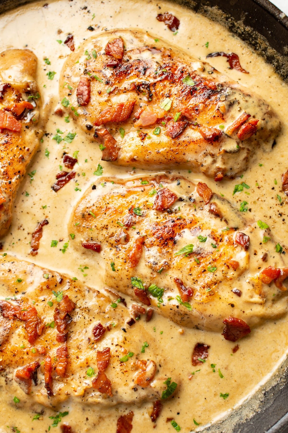 closeup of creamy bacon chicken in a skillet