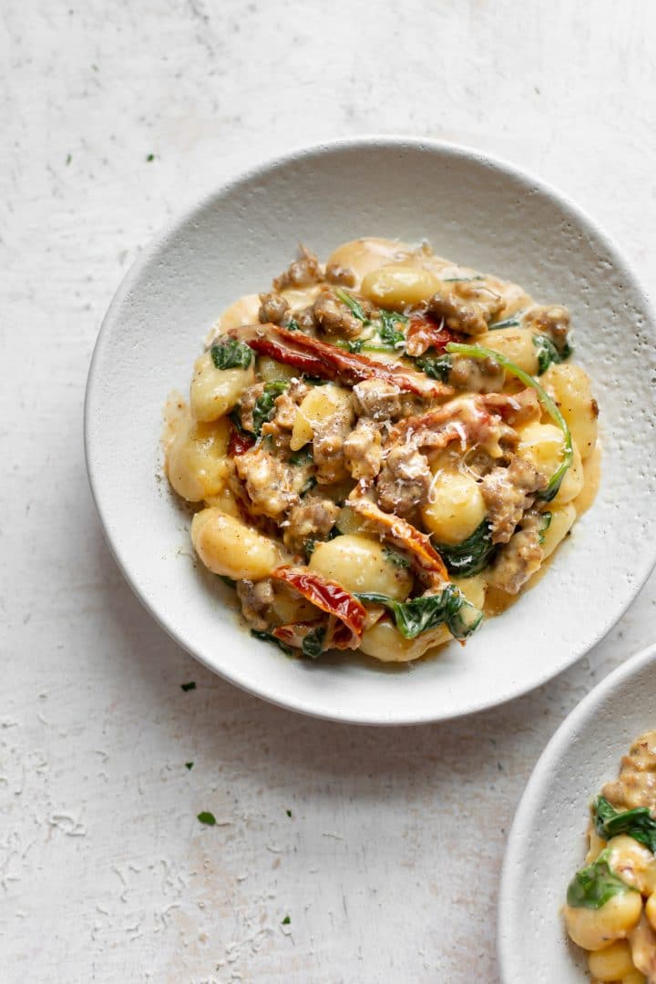 Italian sausage gnocchi in two white bowls