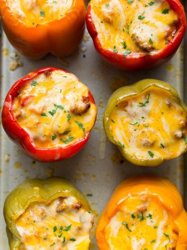 Cheesy sausage stuffed peppers on a baking sheet