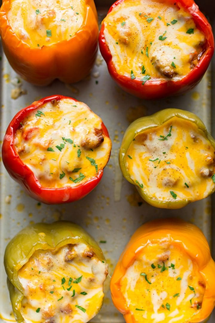 Cheesy sausage stuffed peppers on a baking sheet