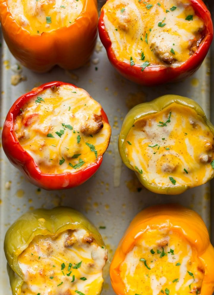 Cheesy sausage stuffed peppers on a baking sheet