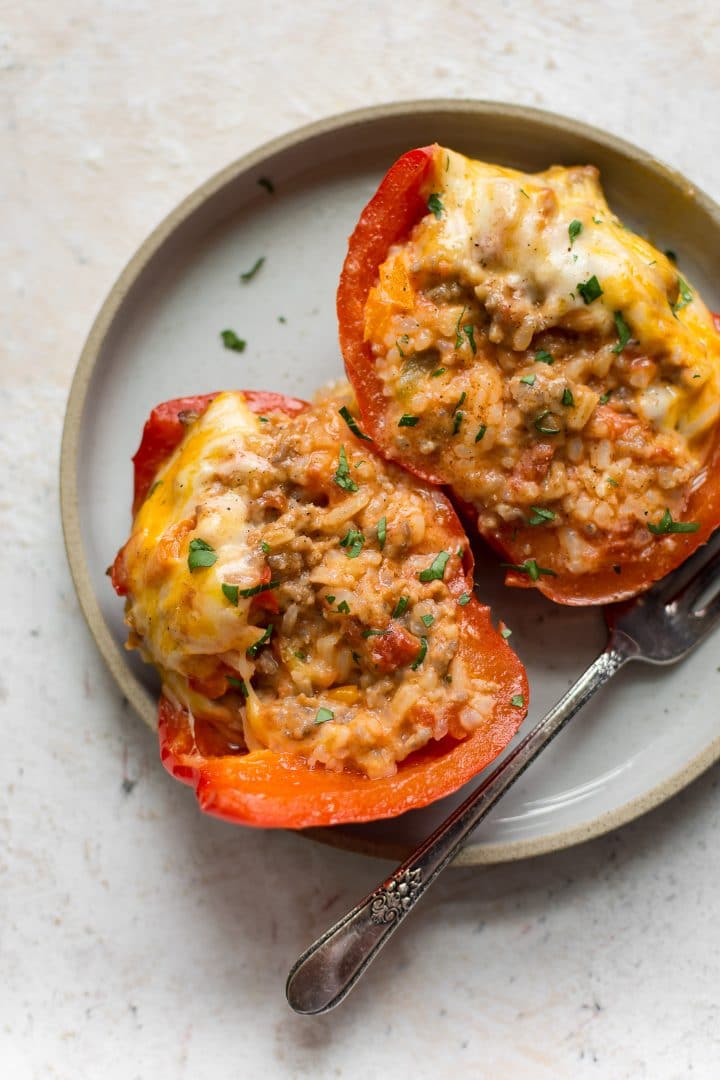 Italian sausage stuffed pepper cut in half on a plate