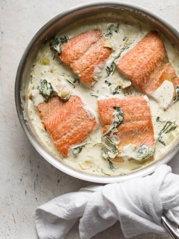 spinach and artichoke salmon in a skillet