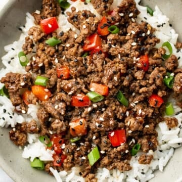 a bowl of asian inspired ground beef over rice