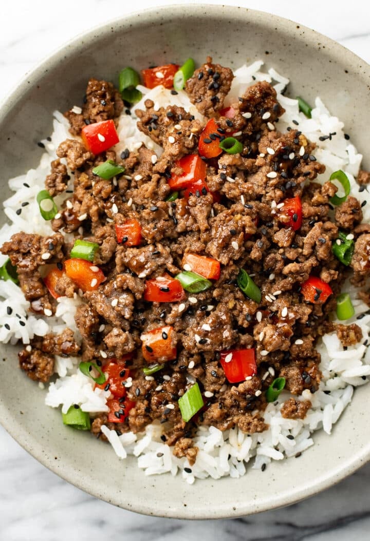 a bowl of asian inspired ground beef over rice