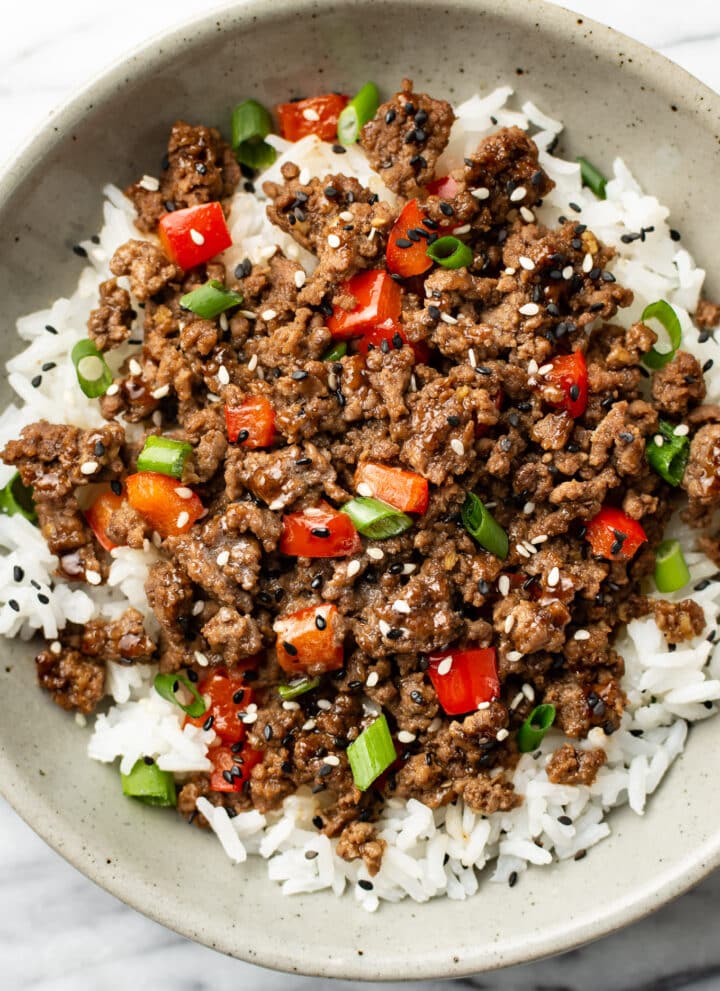 a bowl of asian inspired ground beef over rice