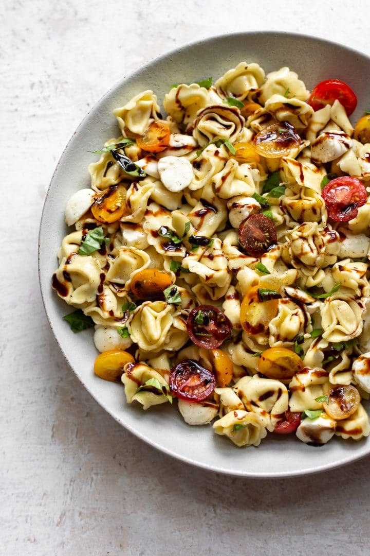 Caprese tortellini pasta salad in a large bowl