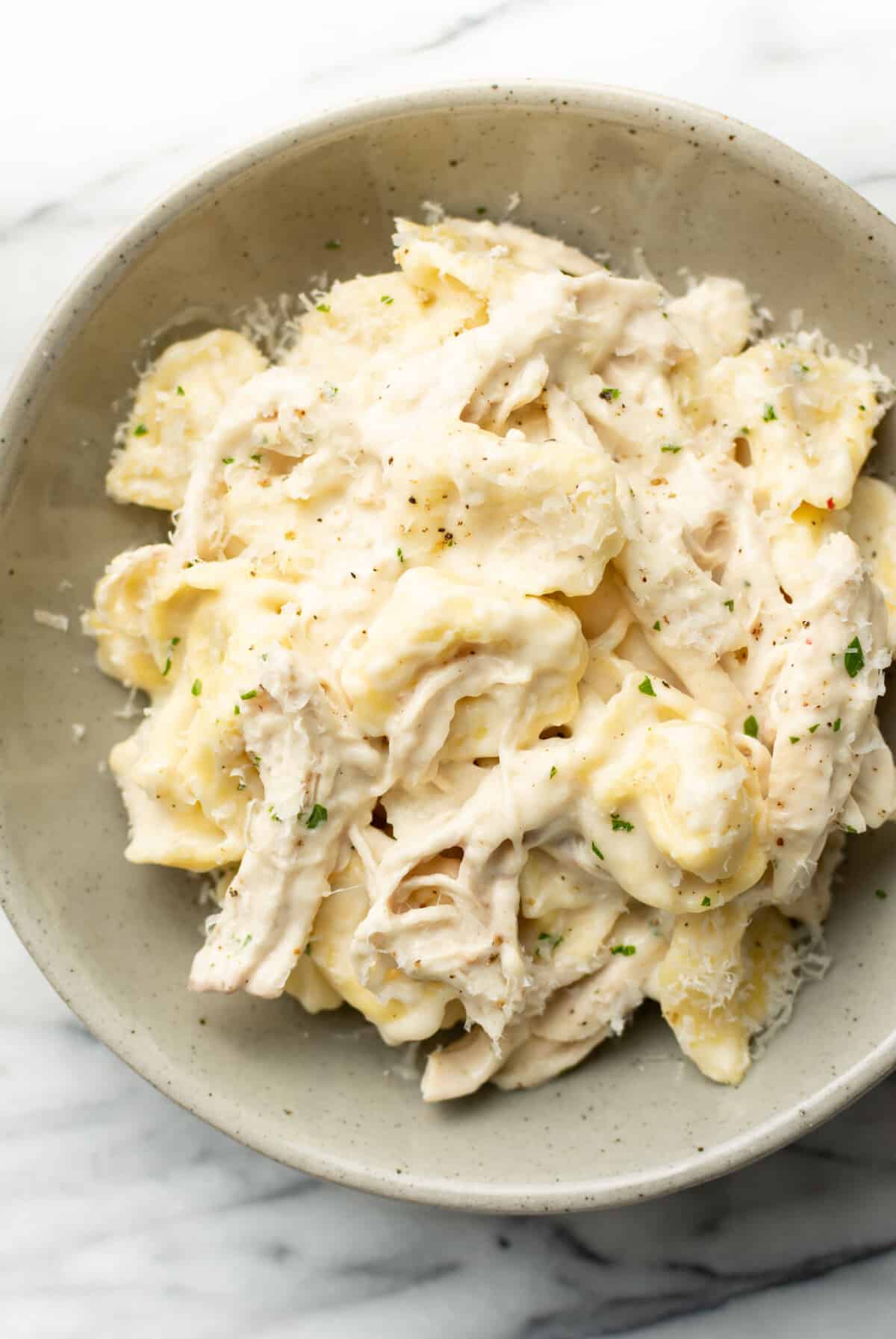 a bowl with chicken tortellini alfredo