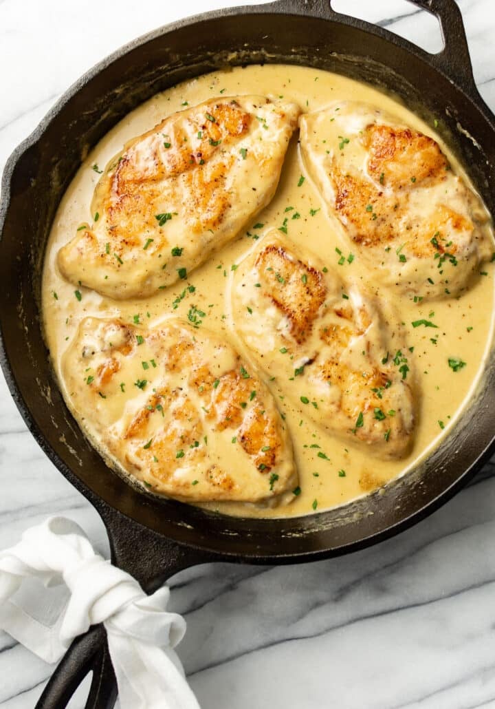 a cast iron skillet with creamy honey mustard chicken