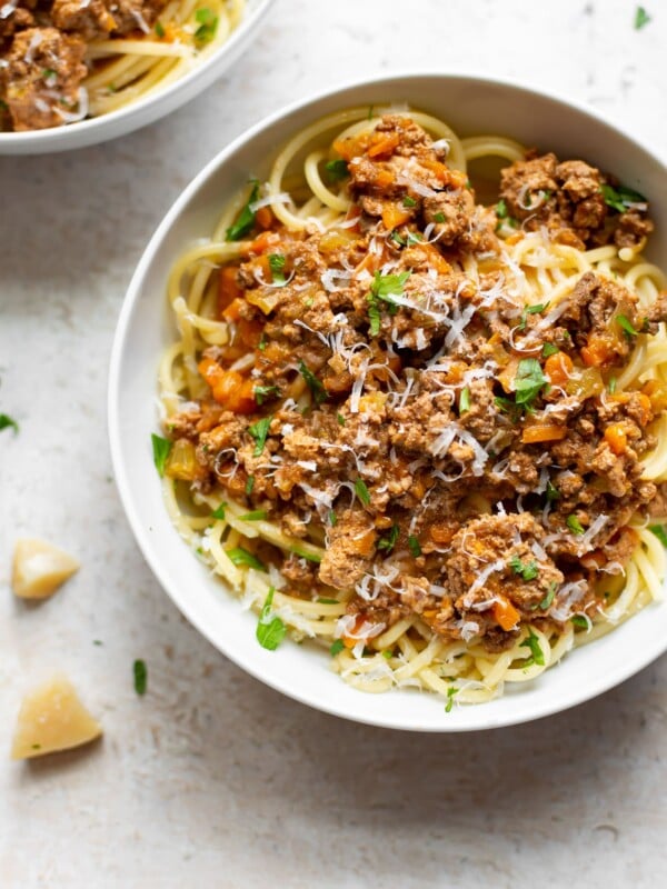 Crockpot ragu in two white bowls with spaghetti