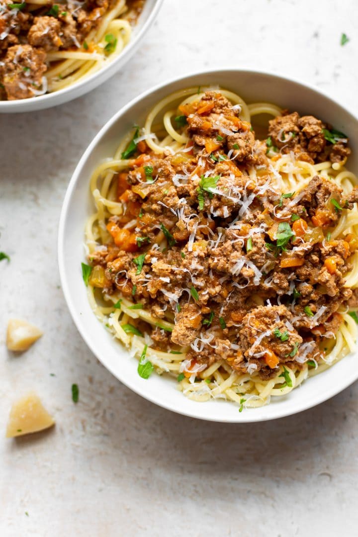 Crockpot ragu in two white bowls with spaghetti