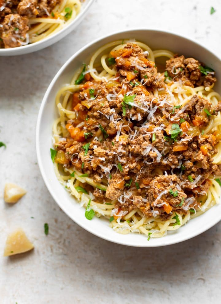 Crockpot ragu in two white bowls with spaghetti