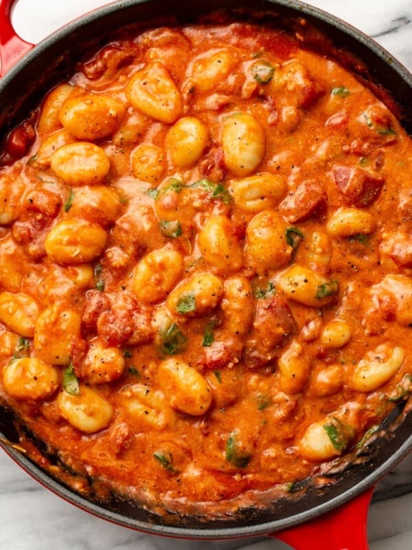 a skillet with gnocchi with tomato sauce