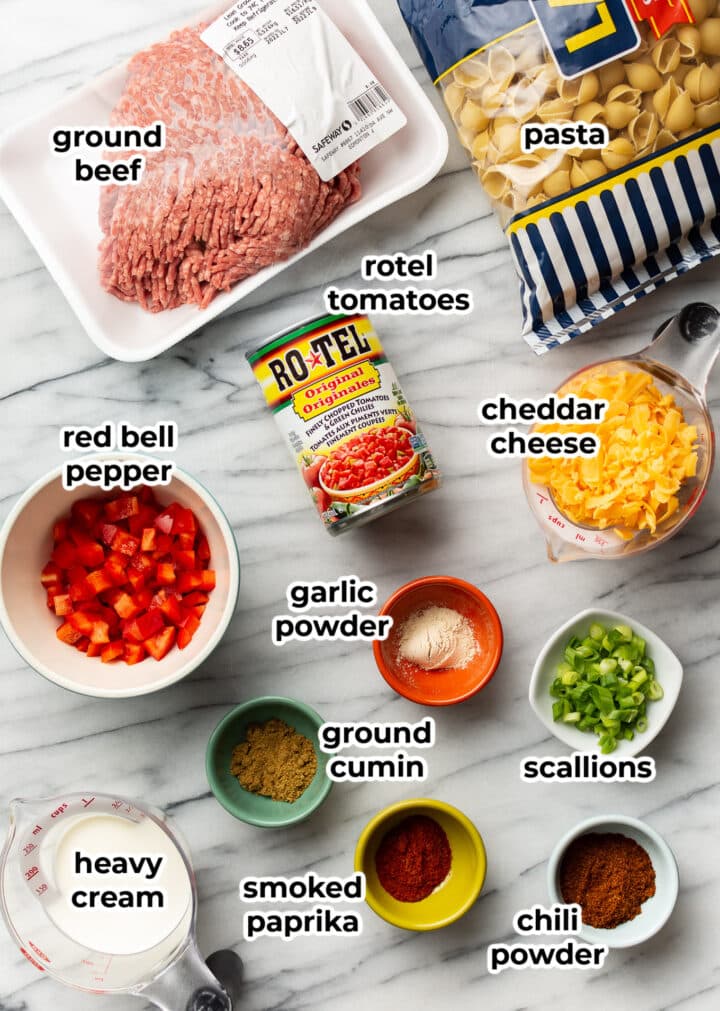 ingredients for cheesy taco pasta in small bowls